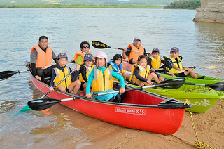 サマーキャンプでカヌー体験をするカブスカウトの隊員ら＝16日午後、名蔵湾