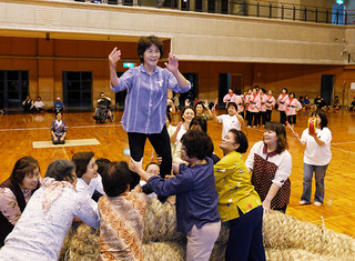 リハーサルでアヒャー綱を再現する新川字会の女性たち＝写真はいずれも29日夜、石垣市総合体育館