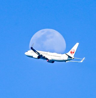月と重なる飛行機の写真＝2日午後4時半ごろ、仲村渠麻里奈さん撮影